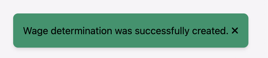 Green success toast confirming wage determination was successfully created
